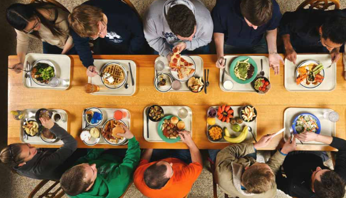 Students gathered around a dinning table